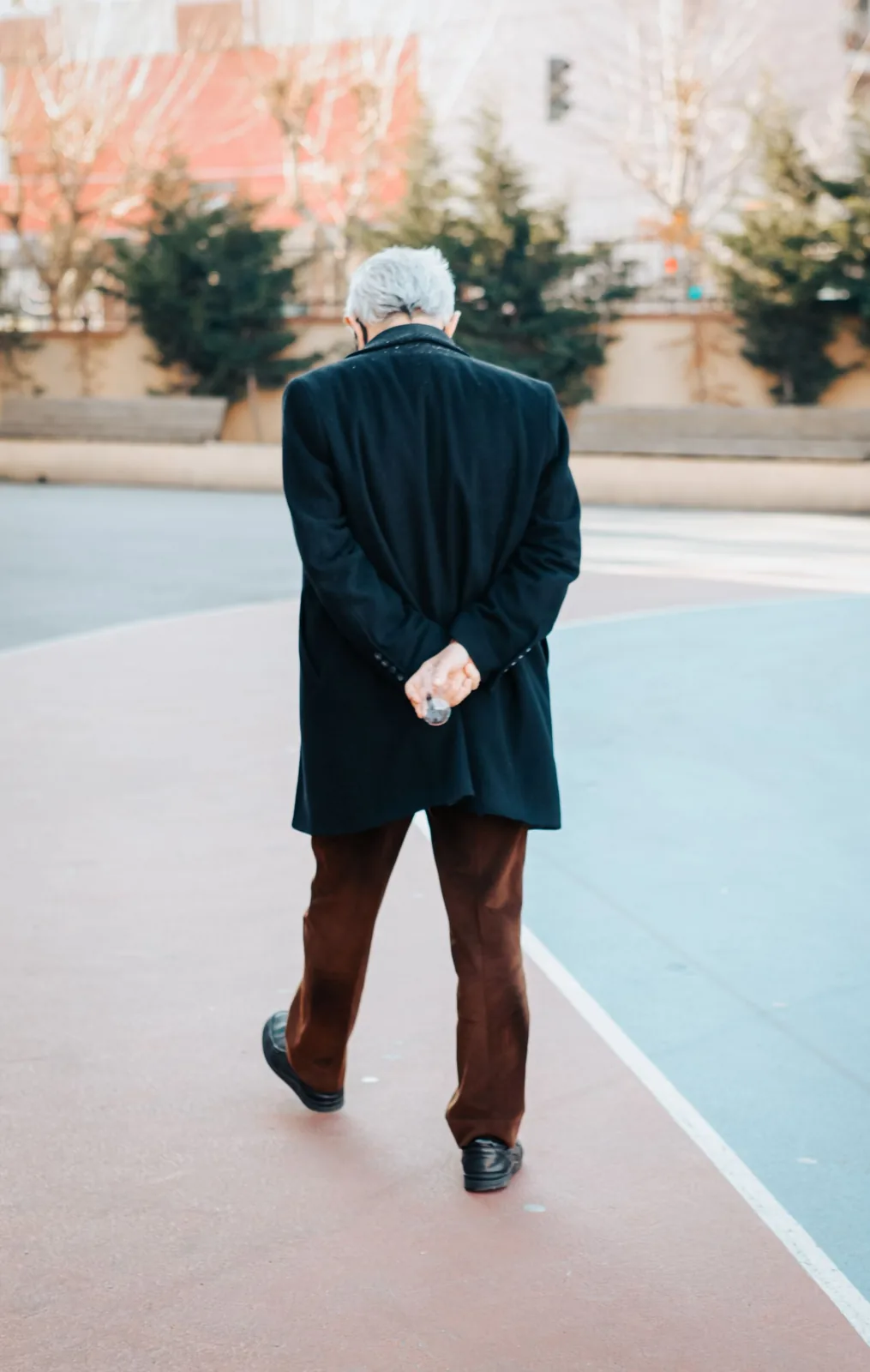 Older man taking a relaxed daytime walk outdoors