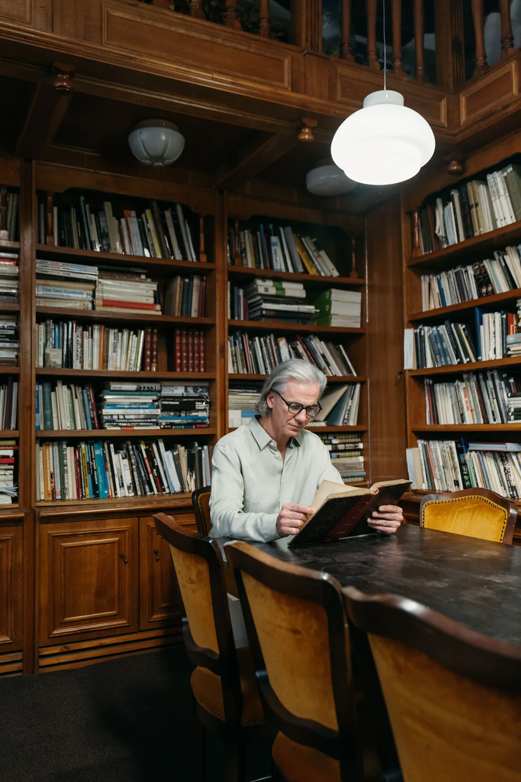 Older man reading in a quiet evening setting
